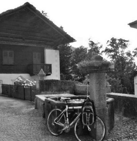 a bike parked in front of a house at bb chiavenna centro storico in Chiavenna
