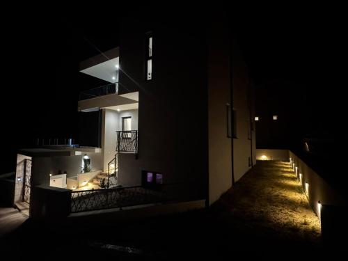 a building at night with lights on the side at Villa Solas Lux Makarska - Veliko Brdo in Veliko Brdo