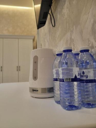 three bottles of water are sitting next to a toaster at MIRON Hotel in Samarkand