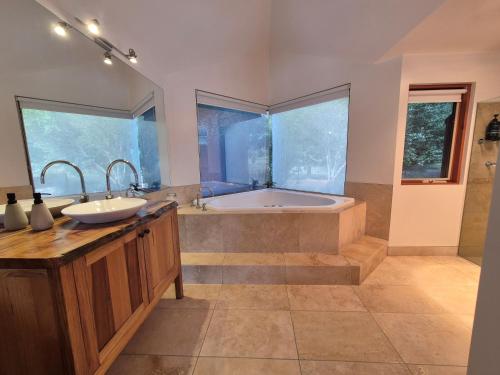 a bathroom with a tub and a sink at Adventure Bay Retreat Bruny Island in Adventure Bay