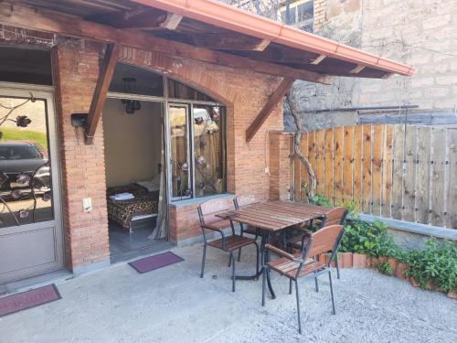 a wooden table and chairs on a patio at Old Gate Inn in Akhaltsikhe