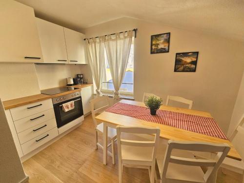 a kitchen with a table and chairs in a kitchen at Old Town Modern Charm Apartment in Hall in Tirol
