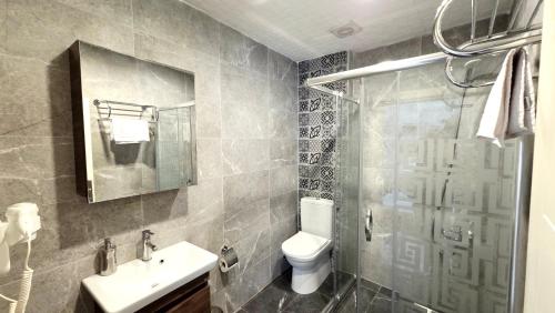 a bathroom with a toilet and a sink and a shower at Social House Istanbul in Istanbul