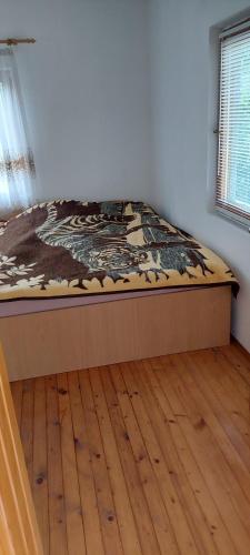 a bed in a room with a wooden floor at Pet friendly Landhaus in Modriča