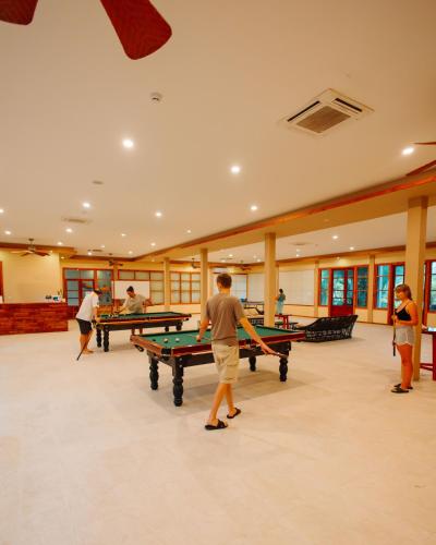 a group of people playing ping pong in a room at Brennia Kottefaru Maldives in Raa Atoll