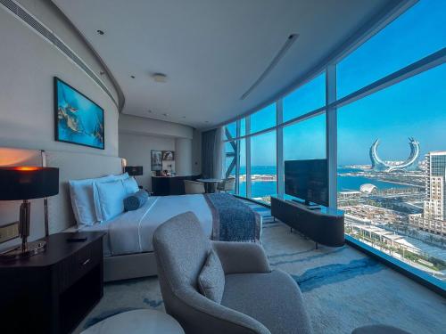 a hotel room with a bed and a large window at Century Marina Hotel - Lusail in Lusail