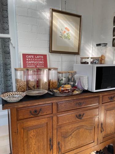 a counter with a microwave and some food on it at Franklin Lodge, Huon Valley, Tasmania, Lavender Room in Franklin