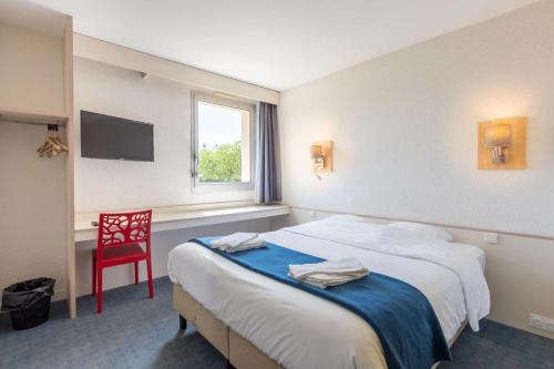 a hotel room with two beds and a red chair at Hôtel La Petite Auberge in Chambretaud