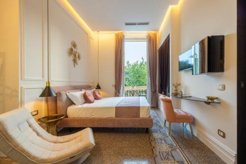 a hotel room with a bed and a chair at Villa Libertà in Palermo