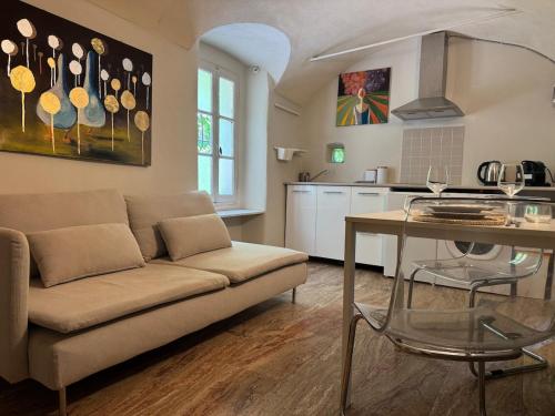 a living room with a couch and a table at La piazzetta in Arma di Taggia