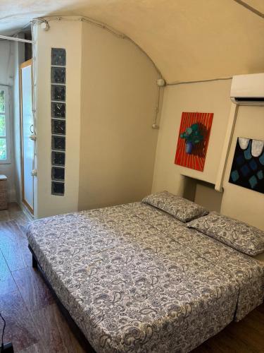 a bedroom with a bed and a painting on the wall at La piazzetta in Arma di Taggia