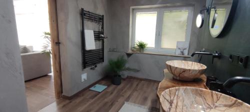 a bathroom with a bowl sink and a mirror at Home sweet Home in Havelberg
