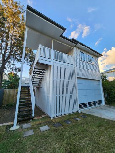 a house with a staircase and a garage at OXLEY Mineral Pool & Private Home suburbanSTAY in Brisbane