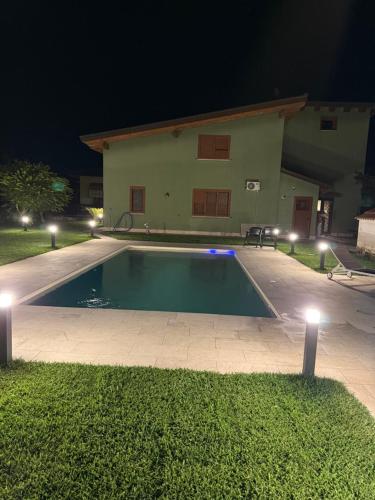 a swimming pool in front of a house at night at Santa Maria Apartments in Forino