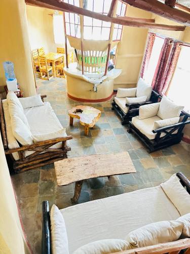 a living room with couches and chairs and a boat at Leleshwa house in Ngong