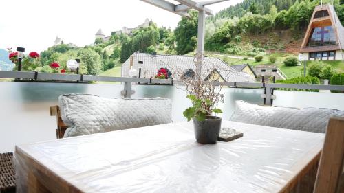 a table with a potted plant on top of a balcony at Lerchenhof in Friesach