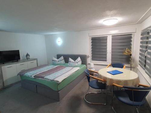 a bedroom with a bed and a table and chairs at Ferienhaus Cziuppa in Bad Salzungen