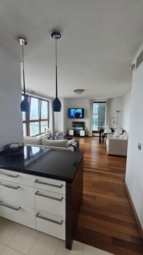 a living room with a couch and a table at Sea Towers Luxury Apartment in Gdynia