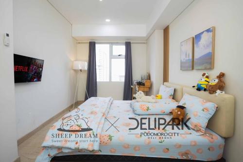 a bedroom with a bed with stuffed animals on it at Delipark Mall 2 Bedrooms 2 Bathrooms 4-6 Pax Lincoln Tower Level 5 in Medan