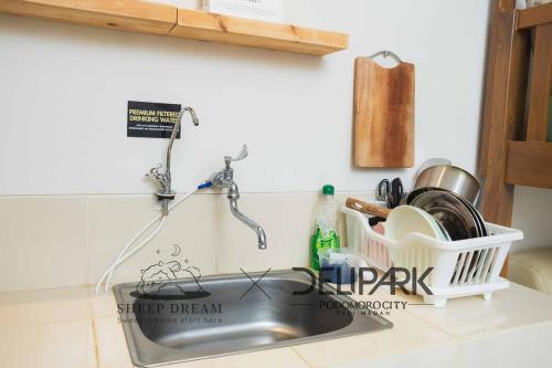 a kitchen sink with a dish drying rack next to it at Delipark Mall 2 Bedrooms 2 Bathrooms 4-6 Pax Lincoln Tower Level 5 in Medan