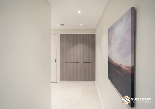 a hallway with a door and a painting on the wall at Fashion Avenue Dubai Mall in Dubai