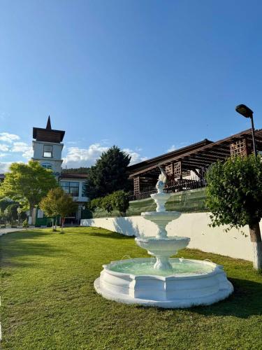 a fountain in a park with a building in the background at Studio D07 in Rogachevo