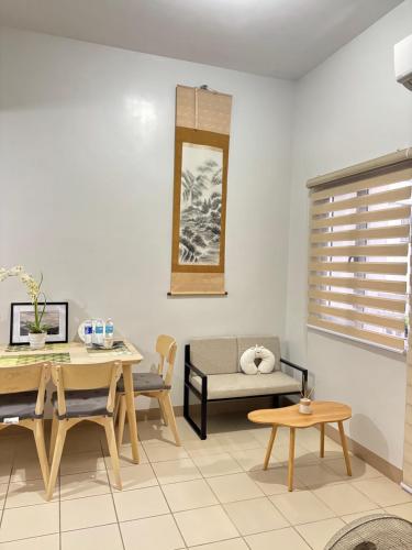 a living room with a table and a dining room at 40sqm Minimalist Condo w Balcony SM Marilao in Marilao