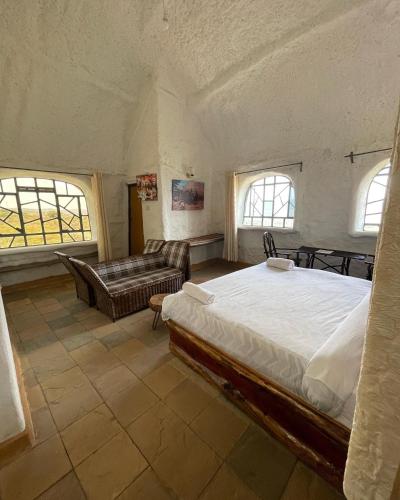 a large bedroom with a bed and a couch at Lion king house 4 bedroom villa in Kiserian