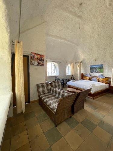 a large bedroom with a bed and a couch at Lion king house 4 bedroom villa in Kiserian