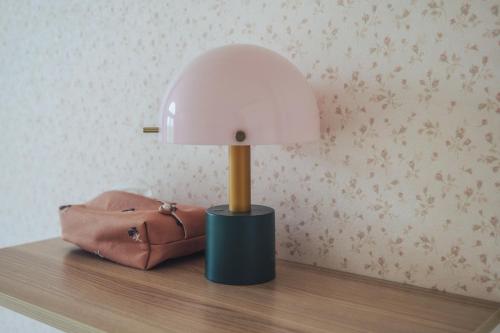 a lamp on top of a table with a purse at 伊豆集 Episode IZU in Ito