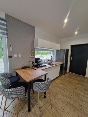 a kitchen with a wooden table and chairs at Chill Chaty in Tarnobrzeg