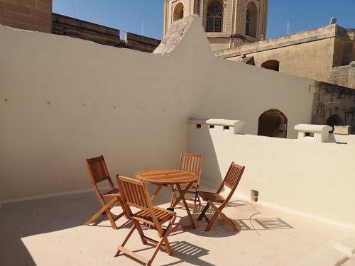 a table and chairs on the roof of a building at 17 Domus Mariae Town House in Senglea