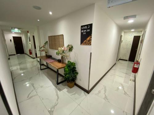 an office hallway with a bench and a sign on the wall at Serapi Hotel in Kuching