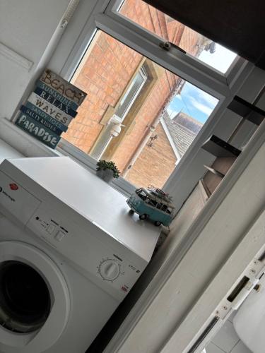 a toy car sitting on top of a washing machine at 2 Bed Apartment Near Yeovil Hospital & Leonardo in Yeovil