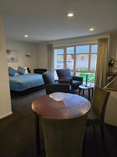 un soggiorno con un letto e un tavolo di Cedar Grove Motor Lodge a Nelson