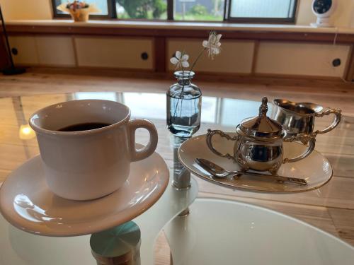 a cup of coffee on a plate on a table at Tanonagano Yadokko - Vacation STAY 26911v in Goshogawara