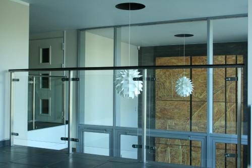 a glass door with two lights in a room at Sea Apartment in Gdańsk