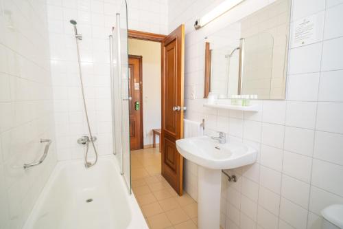 a bathroom with a sink and a shower and a toilet at Hotel La Terraza in Sanxenxo