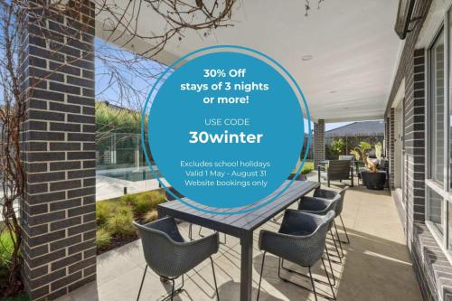 a sign for a patio with a table and chairs at Park Front Villa with sparkling swimming pool in Saint Leonards
