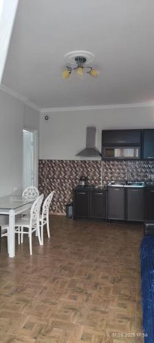 a kitchen and dining room with a table and chairs at Ana hotel in Ureki