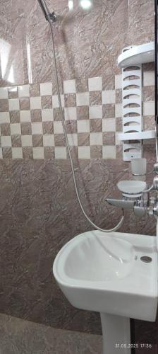 a bathroom with a white sink and a shower at Ana hotel in Ureki