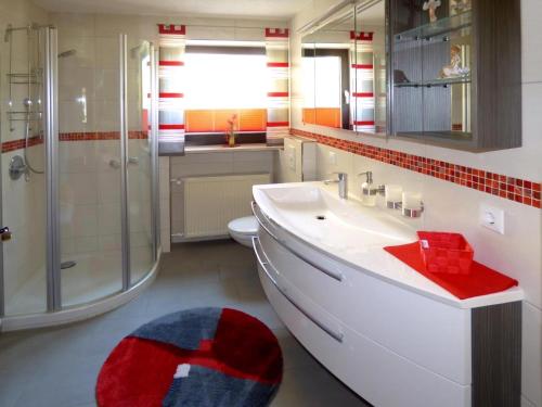 a bathroom with a sink and a shower and a toilet at Komfortable Ferienwohnung Mit Garten Und Grill in Gleißenberg