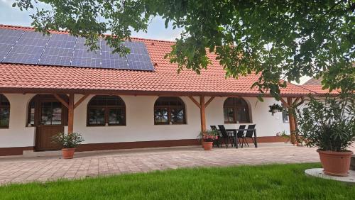 a house with solar panels on the roof at VárLak in Várbalog