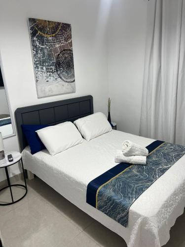 a bed with two pillows and a blanket on it at Kineret sheli- 4Bedrooms luxury apartment with stunning lake view in Tiberias