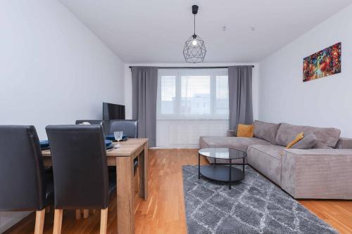 a living room with a couch and a table at Mozartova- Quiet Getaway with a view of the Danube in Bratislava