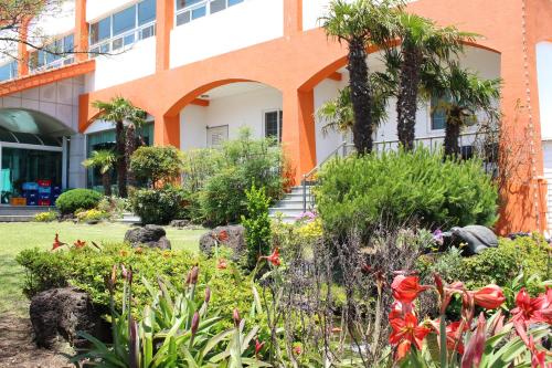 a garden in front of a building at Jeju Feel House in Jeju