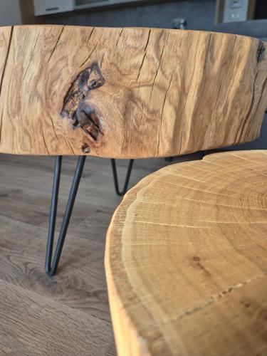 a close up of a wooden table with a wooden bench at Jen tak Lipno in Lipno nad Vltavou