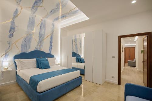a bedroom with a bed with a blue headboard at L'Orchidea Blu in Pianillo