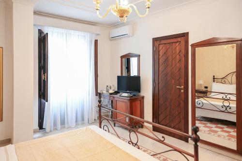 Postel nebo postele na pokoji v ubytování Hotel Palazzo Krataiis