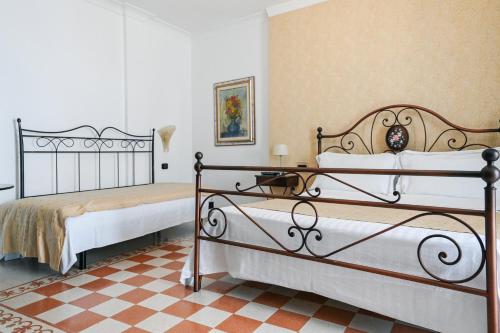 Postel nebo postele na pokoji v ubytování Hotel Palazzo Krataiis